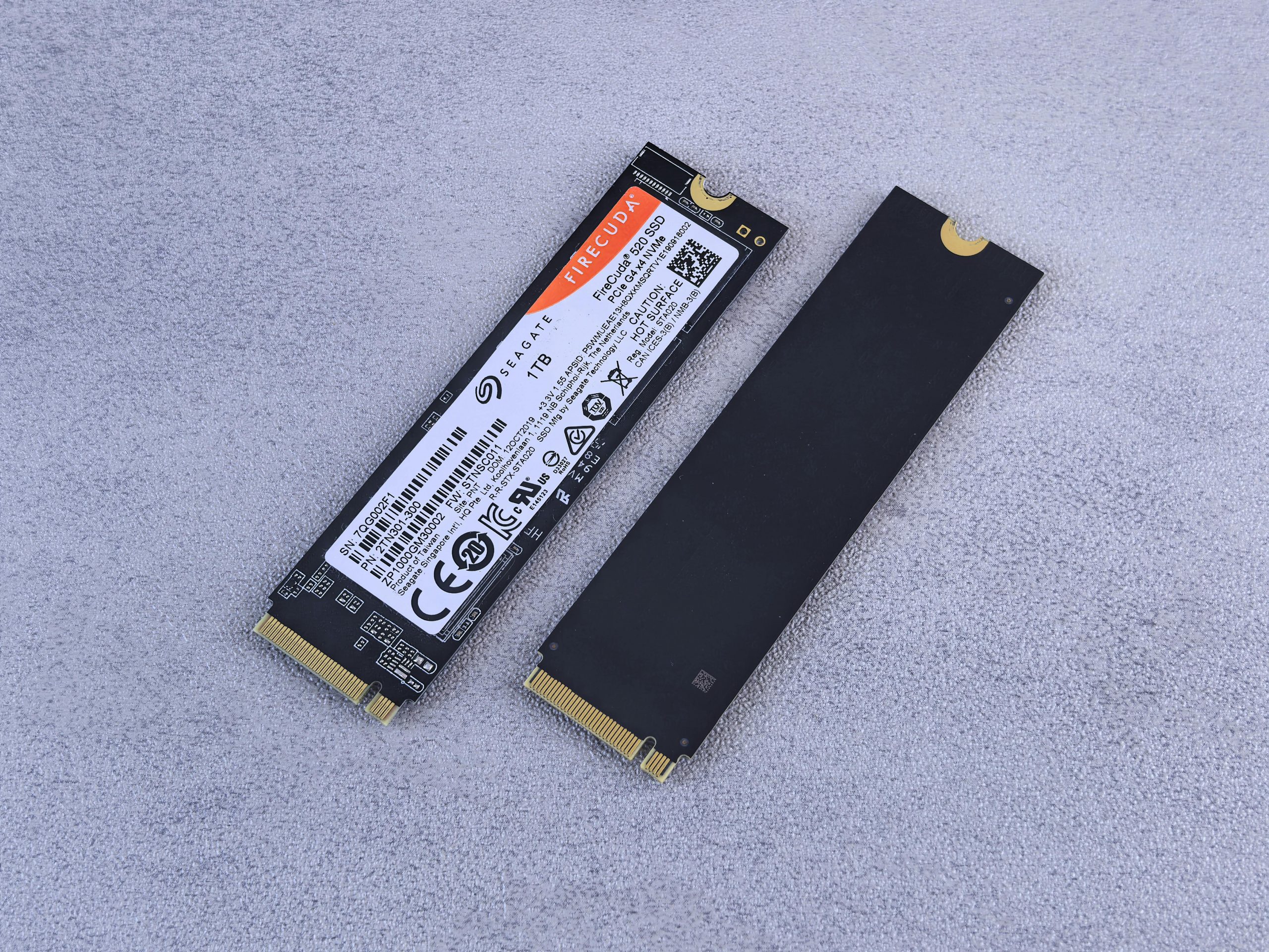 Home Two NVMe SSDs, Seagate FireCuda, on a gray background for tech enthusiasts.